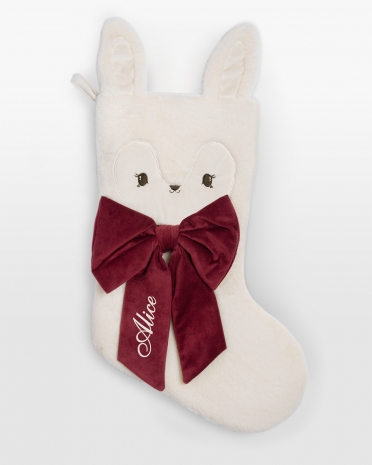 Valkoinen joulusukka teddykankaasta punaisella rusetilla ja nimimerkinnällä