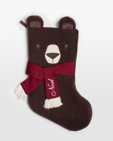 Ruskea joulusukka teddykankaasta punaisella rusetilla ja nimimerkinnällä