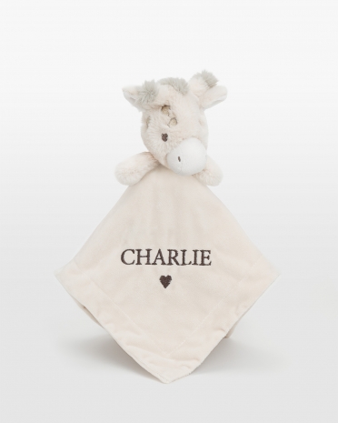 Uniriepu kirahvikuvioinnilla ja brodeeratulla nimellä