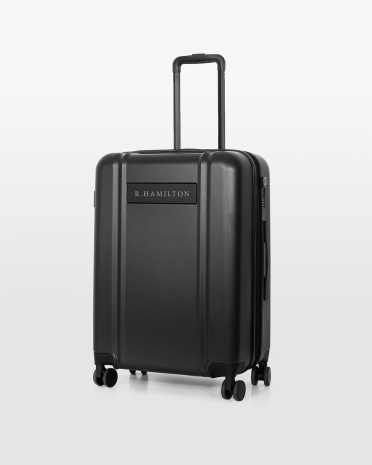 Tummanharmaa matkalaukku nimellä ja mustilla yksityiskohdilla