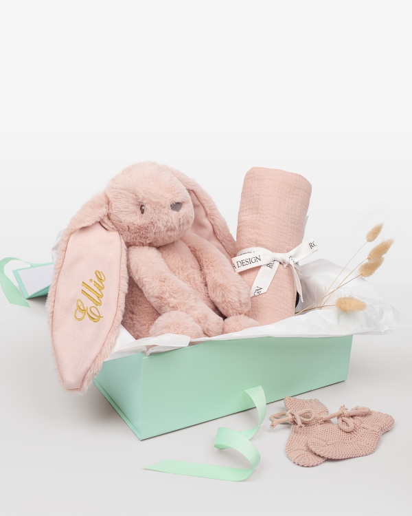 Setti, johon kuuluu nimikoitu pehmopupu, musliinipeitto ja neulotut tossut vastasyntyneelle