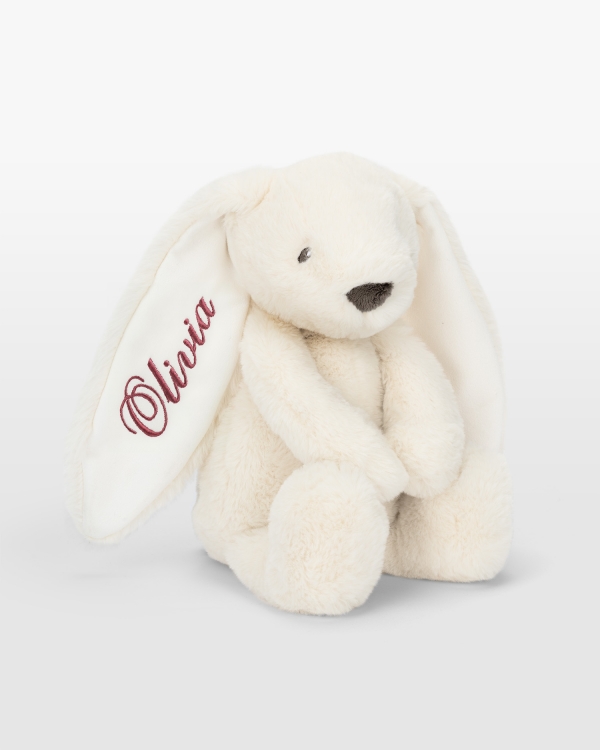 Kermanvärinen kani tummanpunaisella brodeerauksella