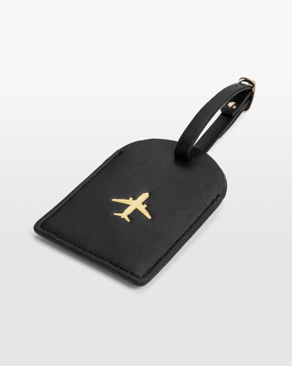 Matkalaukkataggy, jossa on osoitetiedot mustasta vegaaninahasta