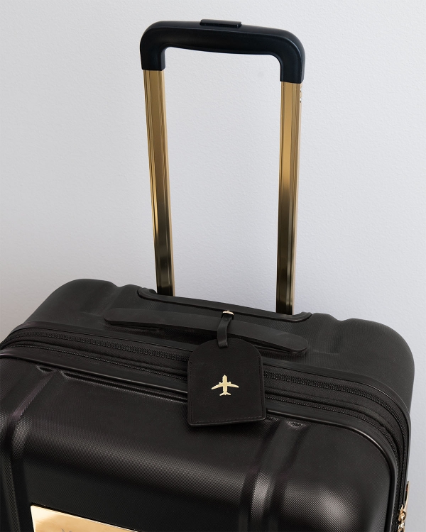 osoitelappu matkalaukkuun mustana kultayksityiskohdilla