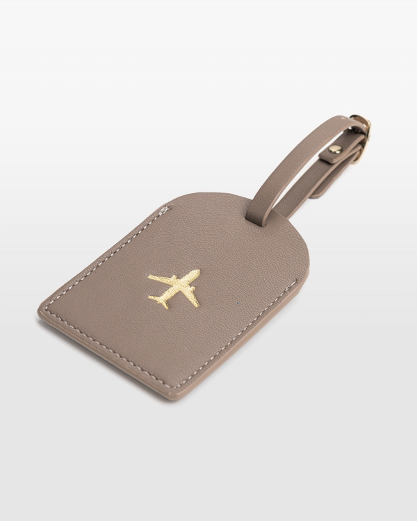 Matkalaukkataggy, jossa on paikka yhteystiedoille