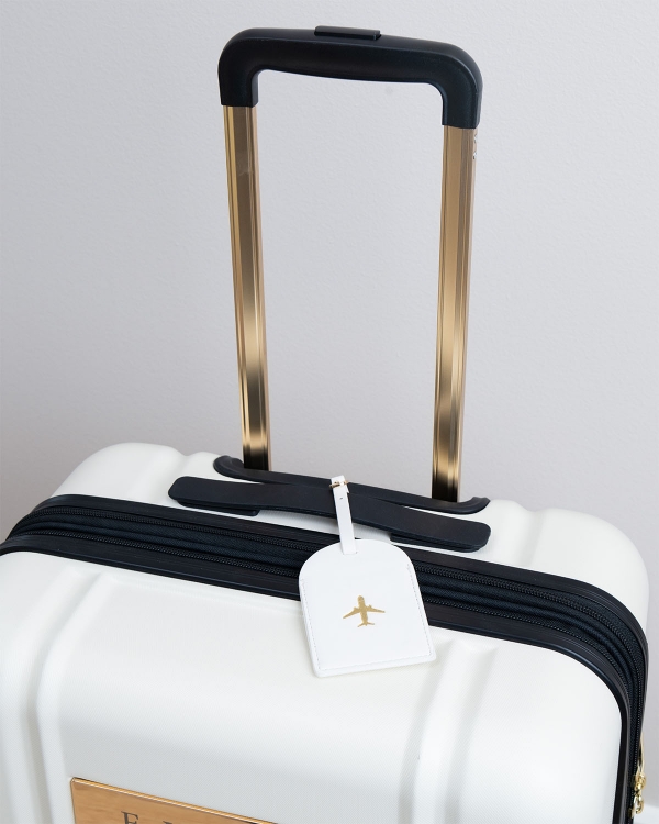 matkatavaratunniste osoitetiedoilla, kermanvärisestä keinonahasta