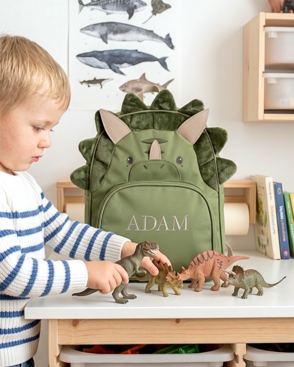 Lasten dinosauruksen muotoinen reppu, jossa on kirjailtu nimi