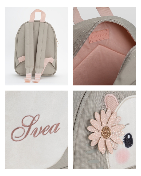 Harmaa lastenreppu, jossa kimaltava kukka ja siili-motiivi