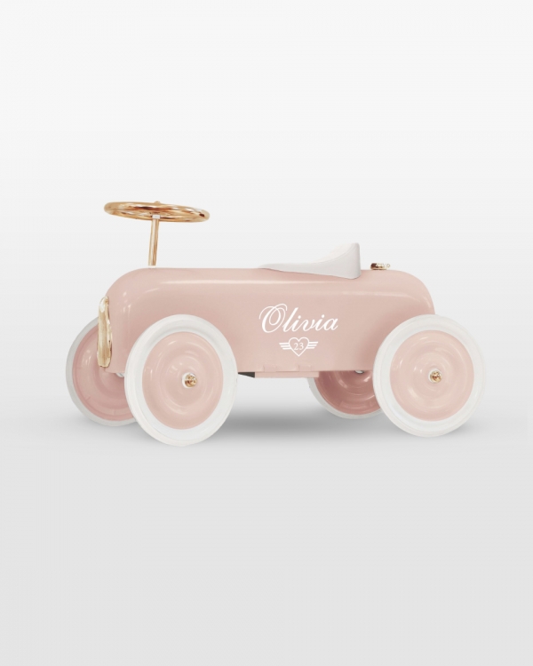 Vaaleanpunainen potkuauto nimellä